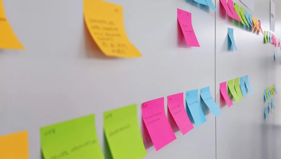 Colourful sticky notes arranged on a whiteboard during project planning